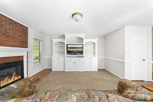 14812 Stonegreen Ln, Huntersville, NC 28078 - living area with wood finished floors, a brick fireplace, and baseboards