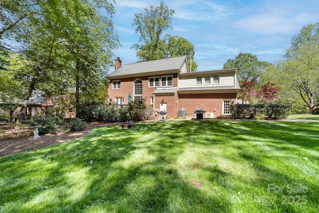 14812 Stonegreen Ln, Huntersville, NC 28078 - rear view of house with a chimney, brick siding, a yard, and cooling unit