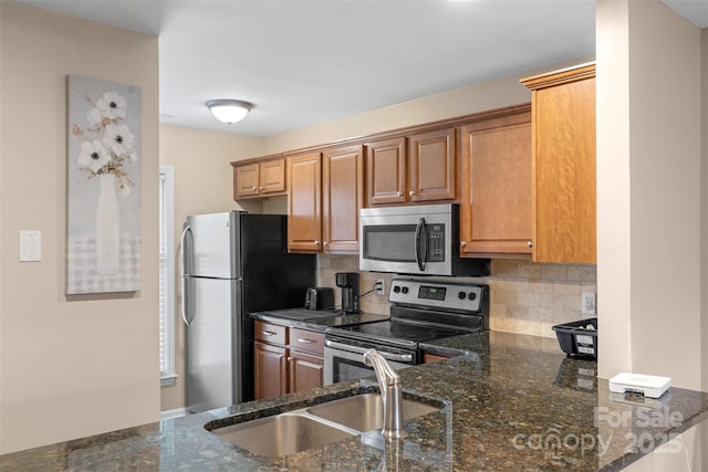 9029 J M Keynes Dr Unit 63, Charlotte, NC 28262 - kitchen featuring dark stone counters, backsplash, stainless steel appliances, and a sink