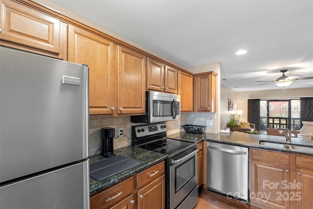 9029 J M Keynes Dr Unit 63, Charlotte, NC 28262 - kitchen featuring a sink, dark wood-style flooring, backsplash, ceiling fan, and appliances with stainless steel finishes