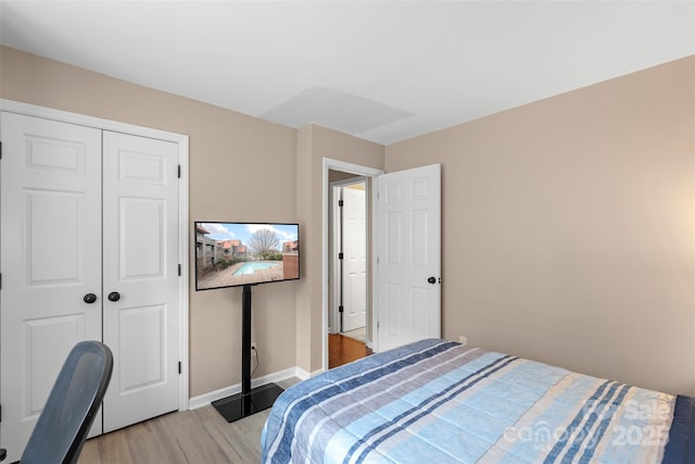 9029 J M Keynes Dr Unit 63, Charlotte, NC 28262 - bedroom featuring baseboards, a closet, and light wood-type flooring