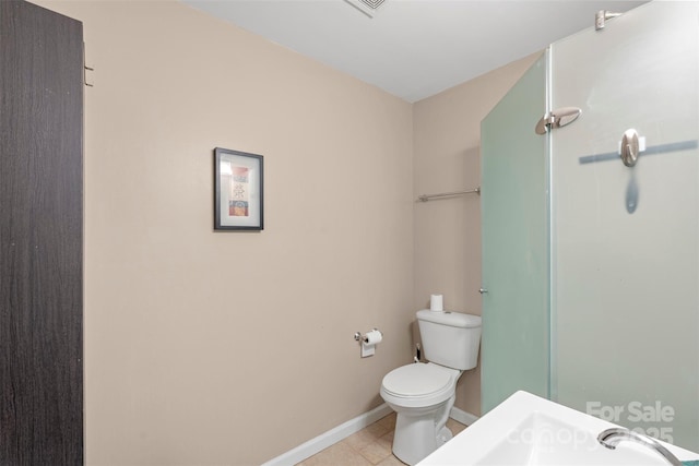 9029 J M Keynes Dr Unit 63, Charlotte, NC 28262 - full bath featuring baseboards, tile patterned flooring, a shower, and toilet