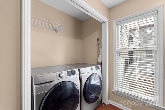 9029 J M Keynes Dr Unit 63, Charlotte, NC 28262 - laundry area featuring plenty of natural light, washing machine and clothes dryer, and baseboards