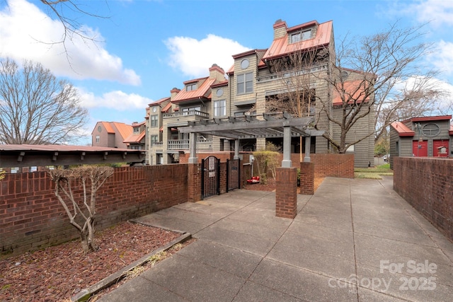 9029 J M Keynes Dr Unit 63, Charlotte, NC 28262 - exterior space featuring a gate, a pergola, a patio area, fence private yard, and a residential view