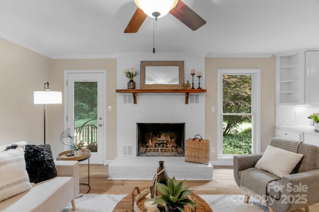 1607 Old Lawyers Rd, Marshville, NC 28103 - living area with crown molding, light wood-style floors, a fireplace, and ceiling fan