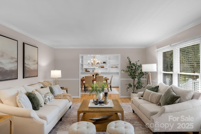 1607 Old Lawyers Rd, Marshville, NC 28103 - living room with light wood-type flooring, a chandelier, crown molding, baseboards, and built in features