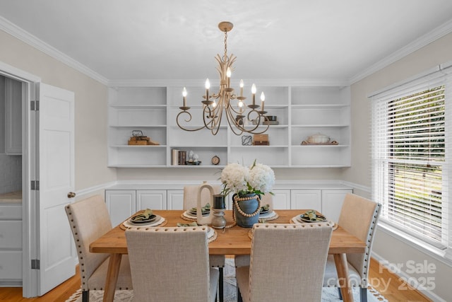 1607 Old Lawyers Rd, Marshville, NC 28103 - dining room with a chandelier, ornamental molding, built in features, light wood finished floors, and a wainscoted wall