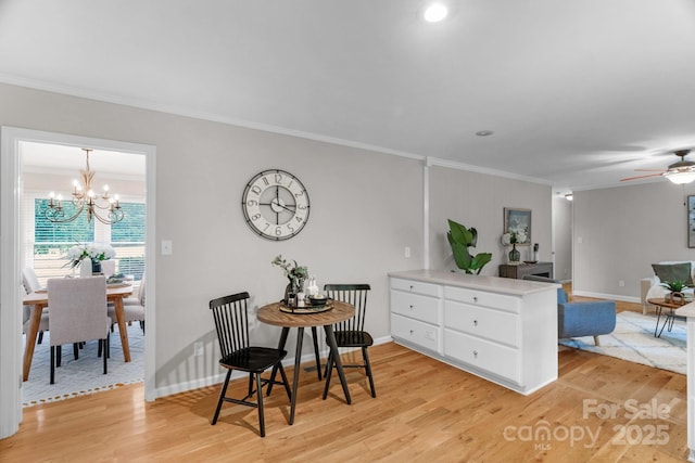 1607 Old Lawyers Rd, Marshville, NC 28103 - dining space with ornamental molding, light wood-style flooring, a chandelier, baseboards, and ceiling fan