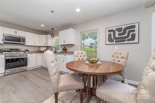 221 Belton Ave, Mount Holly, NC 28120 - dining room with light wood-style flooring and recessed lighting