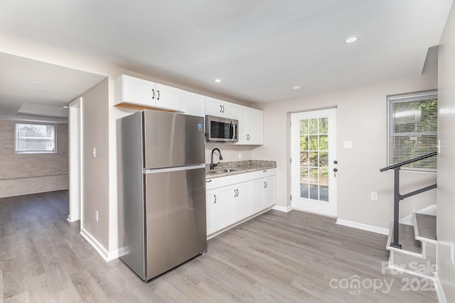 221 Belton Ave, Mount Holly, NC 28120 - kitchen with stainless steel appliances, light wood-style flooring, white cabinets, and recessed lighting