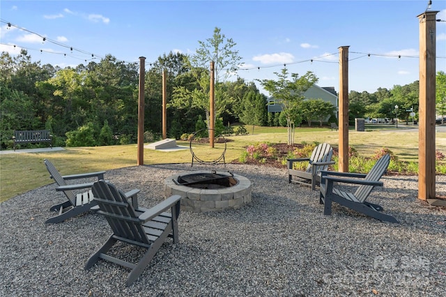 view of yard with a fire pit