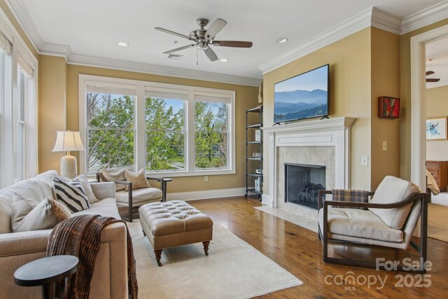 350 E Allen St Unit 201, Hendersonville, NC 28792 - living room with ceiling fan, wood finished floors, a high end fireplace, baseboards, and crown molding