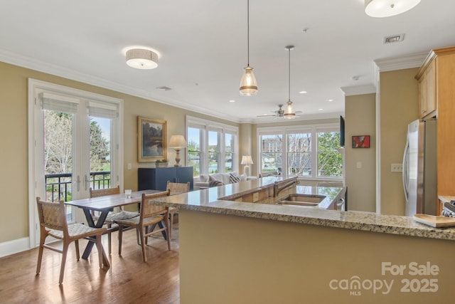 350 E Allen St Unit 201, Hendersonville, NC 28792 - kitchen featuring freestanding refrigerator, a sink, wood finished floors, ornamental molding, and light stone countertops