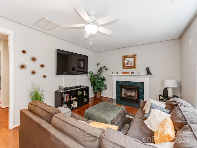 11719 Withers Mill Dr, Charlotte, NC 28278 - living area with wood finished floors, a tile fireplace, ceiling fan, baseboards, and visible vents