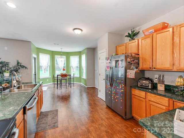 11719 Withers Mill Dr, Charlotte, NC 28278 - kitchen featuring a sink, stainless steel appliances, decorative light fixtures, baseboards, and wood finished floors