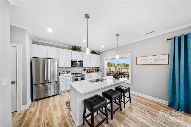 360 N Broad St, Waxhaw, NC 28173 - kitchen with appliances with stainless steel finishes, ornamental molding, a sink, and visible vents