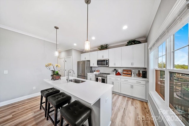 360 N Broad St, Waxhaw, NC 28173 - kitchen featuring a sink, decorative backsplash, light wood finished floors, and stainless steel appliances