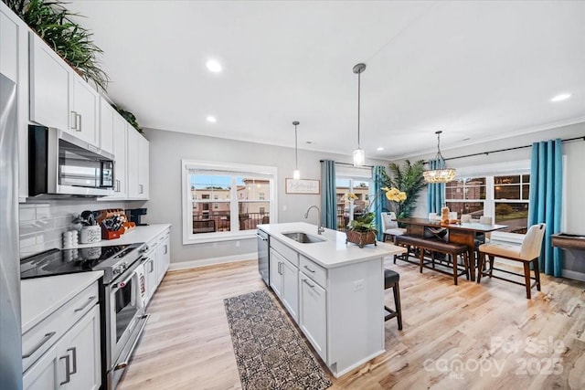 360 N Broad St, Waxhaw, NC 28173 - kitchen with a center island with sink, recessed lighting, light countertops, a sink, and appliances with stainless steel finishes