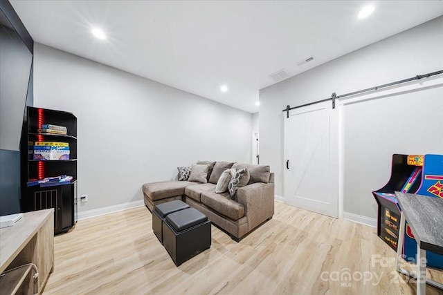 360 N Broad St, Waxhaw, NC 28173 - living room with light wood-style floors, a barn door, visible vents, and recessed lighting