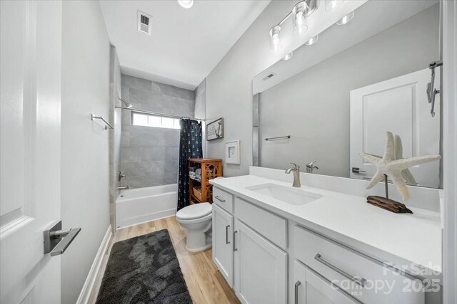 360 N Broad St, Waxhaw, NC 28173 - bathroom featuring vanity, toilet, shower / bath combo with shower curtain, wood finished floors, and visible vents