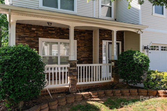 property entrance featuring a porch and stone siding