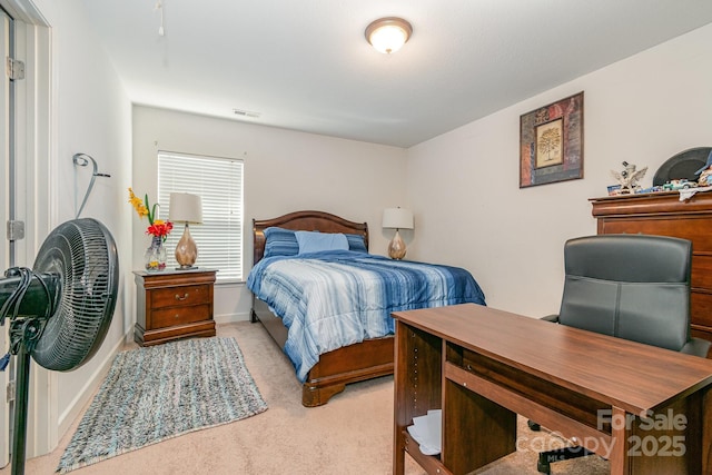 bedroom with baseboards, visible vents, and light carpet