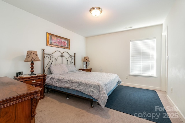 bedroom featuring baseboards, light colored carpet, and visible vents