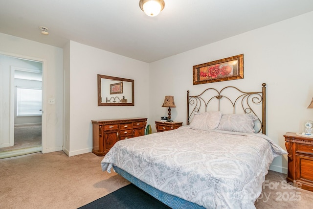 bedroom with baseboards and light carpet