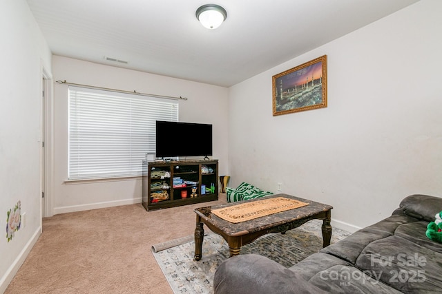 living room with baseboards, visible vents, and carpet