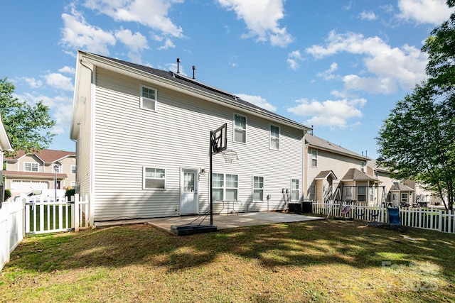 back of property with a fenced backyard, a patio area, a yard, and a residential view