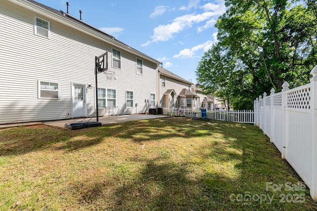 rear view of property featuring a yard, a patio, a residential view, and a fenced backyard
