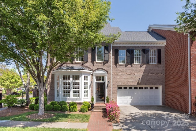6231 Wakehurst Rd, Charlotte, NC 28226 - view of front of house featuring driveway, roof with shingles, an attached garage, and brick siding