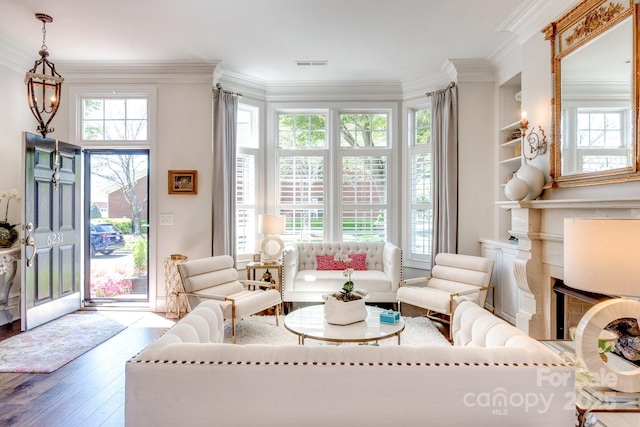 6231 Wakehurst Rd, Charlotte, NC 28226 - living area with wood finished floors, visible vents, crown molding, and built in shelves
