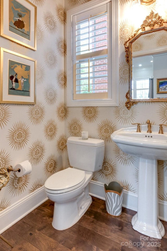 6231 Wakehurst Rd, Charlotte, NC 28226 - half bath with wood finished floors, wallpapered walls, a wealth of natural light, toilet, and baseboards