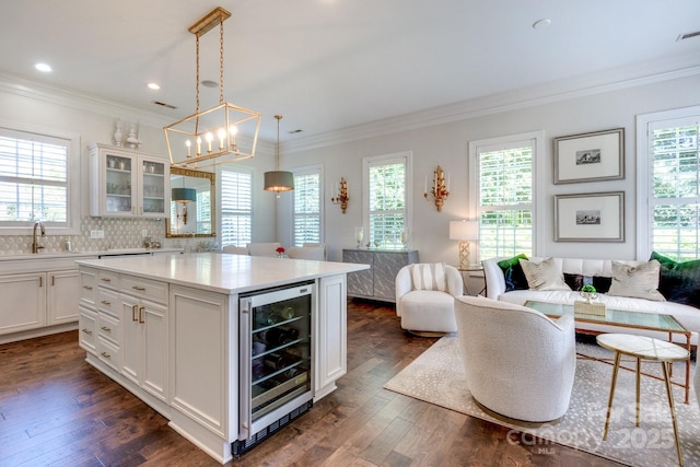 6231 Wakehurst Rd, Charlotte, NC 28226 - kitchen with dark wood finished floors, ornamental molding, a sink, and wine cooler