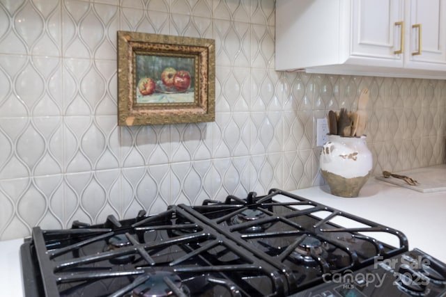 6231 Wakehurst Rd, Charlotte, NC 28226 - interior details with stovetop, white cabinetry, backsplash, and light countertops
