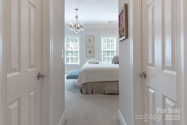 6231 Wakehurst Rd, Charlotte, NC 28226 - carpeted bedroom featuring ornamental molding, visible vents, a notable chandelier, and baseboards