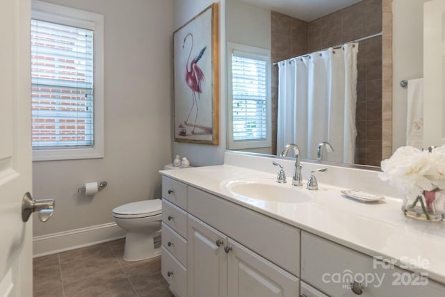 6231 Wakehurst Rd, Charlotte, NC 28226 - bathroom featuring vanity, toilet, a tile shower, baseboards, and tile patterned flooring