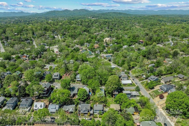 birds eye view of property with a residential view, a view of trees, and a mountain view