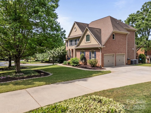 view of front facade with driveway, a front yard, central AC unit, a garage, and brick siding
