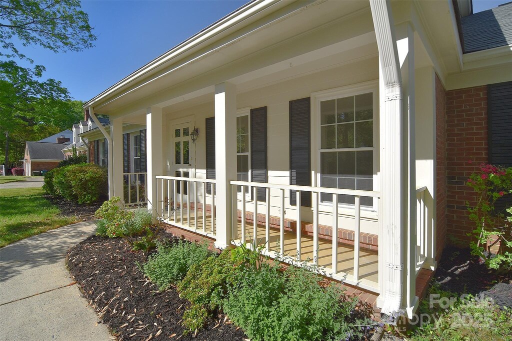 317 Port Royal Dr, Matthews, NC 28105 - view of side of property with brick siding and a porch