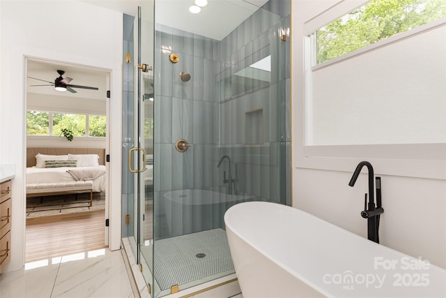 bathroom with a soaking tub, a ceiling fan, ensuite bath, and a stall shower