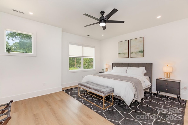 bedroom with baseboards, visible vents, recessed lighting, wood finished floors, and ceiling fan
