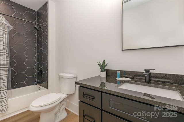 bathroom featuring wood finished floors, toilet, vanity, and shower / bathtub combination with curtain