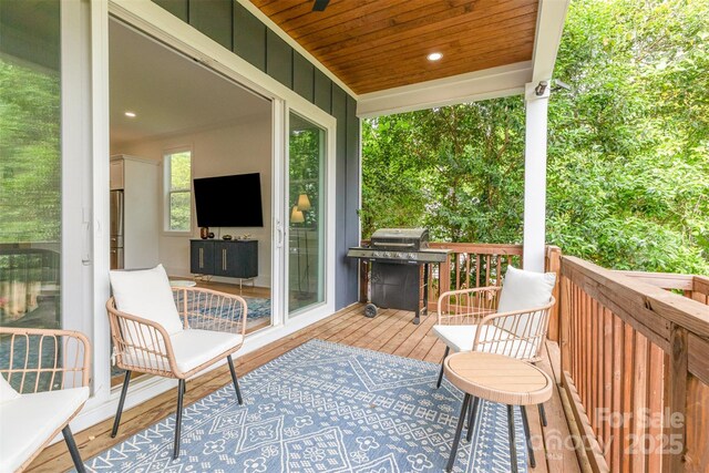 wooden terrace featuring area for grilling