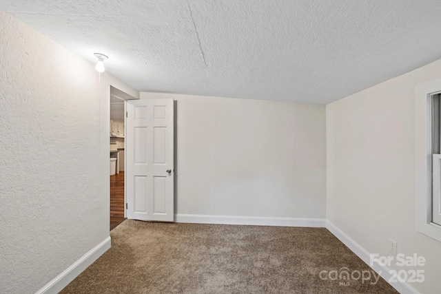 456 Newtown Rd, Rosman, NC 28772 - empty room featuring carpet, a textured ceiling, and baseboards