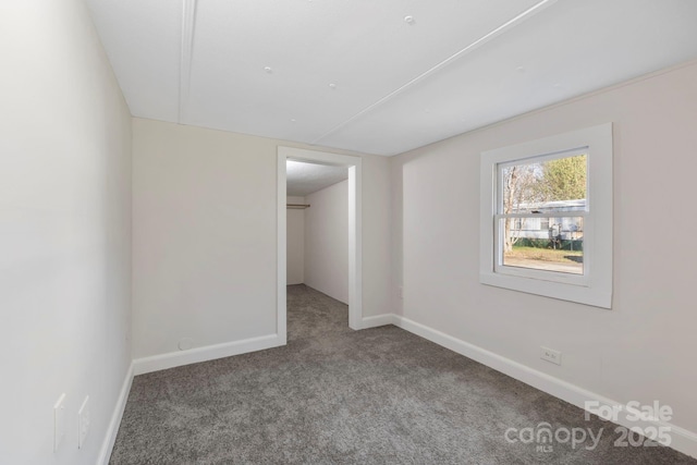 456 Newtown Rd, Rosman, NC 28772 - unfurnished bedroom featuring carpet floors, a spacious closet, and baseboards