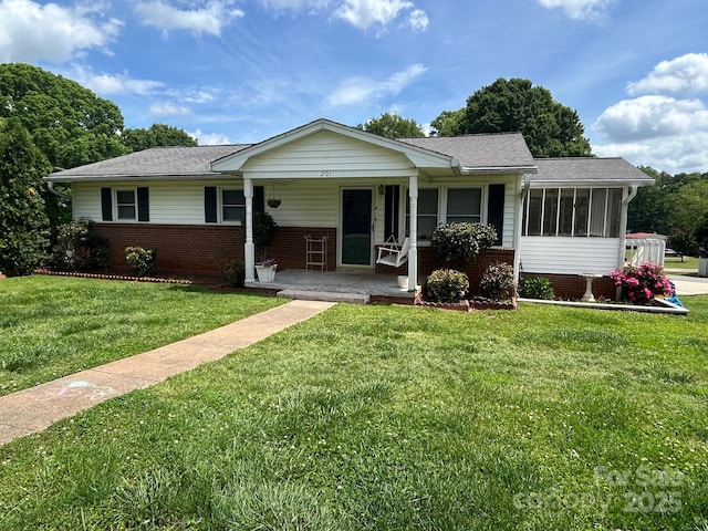 201 Mitchell St, Belmont, NC 28012 - ranch-style house with a porch, a sunroom, a front lawn, and brick siding