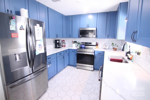 201 Mitchell St, Belmont, NC 28012 - kitchen featuring a sink, backsplash, blue cabinetry, light stone countertops, and appliances with stainless steel finishes