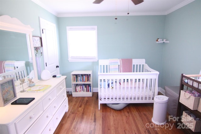 201 Mitchell St, Belmont, NC 28012 - bedroom with wood finished floors, a nursery area, crown molding, baseboards, and ceiling fan